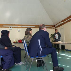 A group of people watch Aga give her presentation on the report