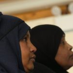 Two Somali women watch the presentation